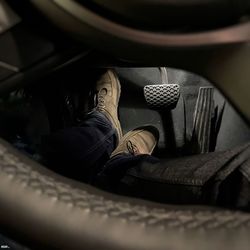 Low section of man sitting in car