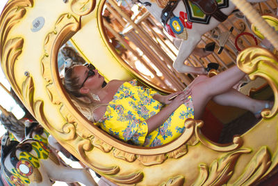 High angle portrait of smiling woman at amusement park