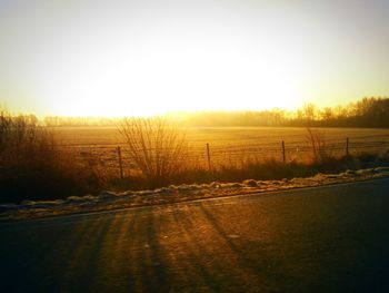 Scenic view of field against clear sky during winter