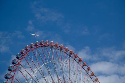 Low angle view of ferris wheel against sky