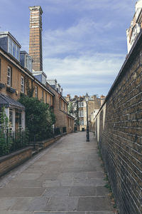 Empty alley amidst buildings in city