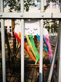 Multi colored flags hanging on railing