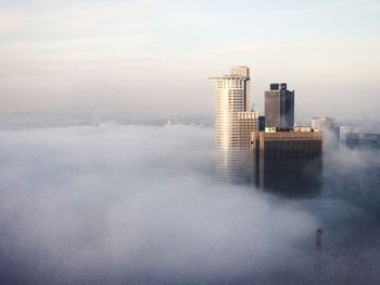 Sea by cityscape against sky