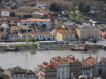 High angle view of townscape by river in city