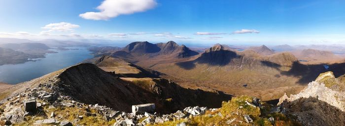 Panoramic view of mountains against cloudy sky