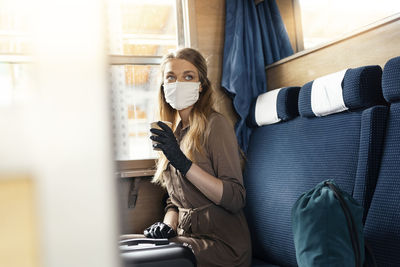 Portrait of woman sitting in corridor