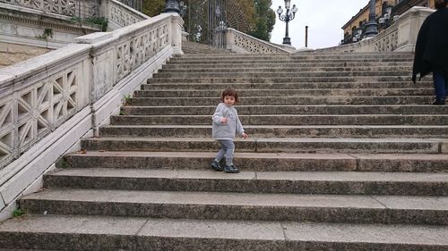 Full length of girl standing on staircase