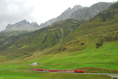 Scenic view of land and mountains against sky