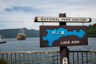 Close-up of road sign by sea