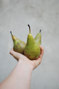 Close-up of hand holding pear