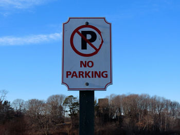Low angle view of road sign against sky