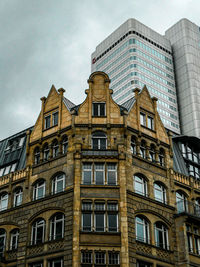 Low angle view of building against cloudy sky