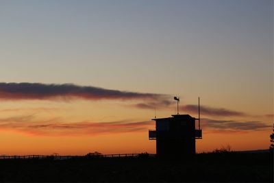 Silhouette of beach against sky during sunset