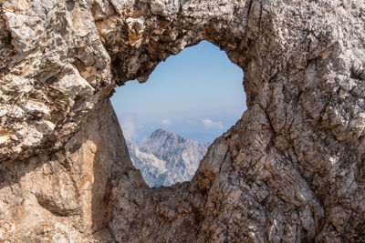 Scenic view of mountains seen through hole