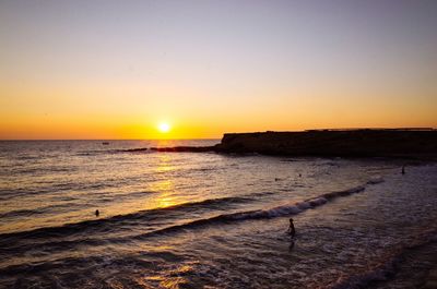 Scenic view of sea against clear sky during sunset