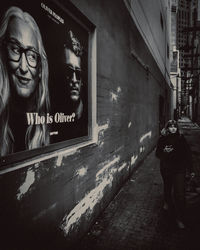 Reflection of people on street in city at night