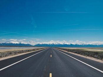 Empty road along countryside landscape