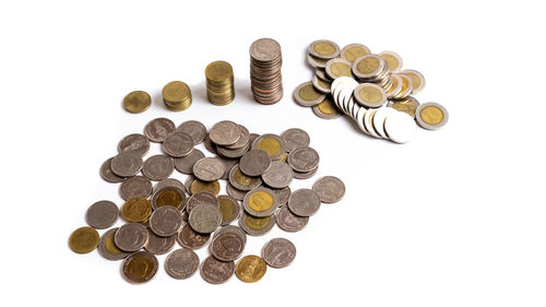 High angle view of coins on white background