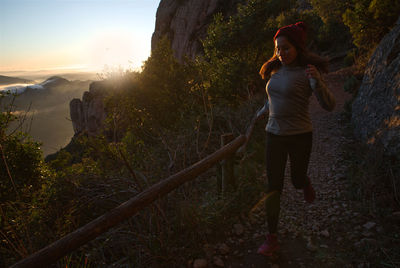 Woman runs through the mountains of montserrat in catalonia, spain.