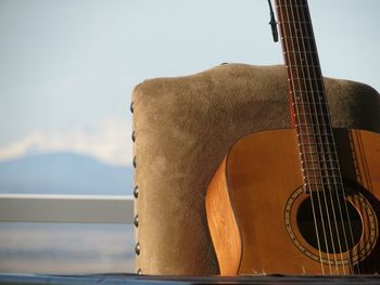 Close-up of guitar against sky