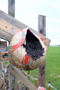 Close-up of wooden post against sky