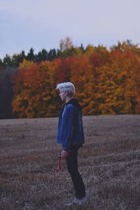 Full length of man walking on field during autumn