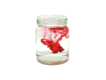 Close-up of glass jar against white background