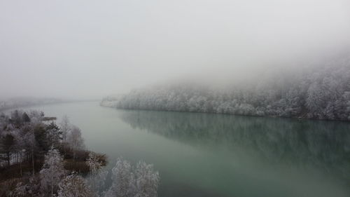 Scenic view of lake against sky during winter