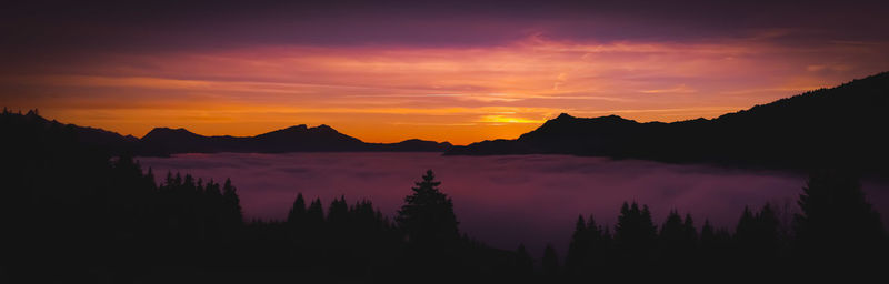 Scenic view of silhouette mountains against sky during sunset