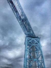 Low angle view of crane against sky