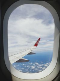 Airplane wing seen through window