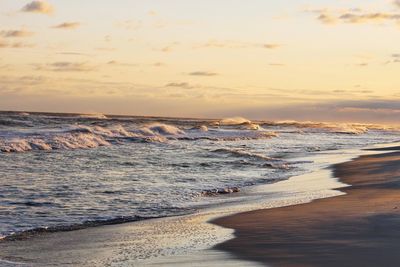 Scenic view of beach against sky during sunset