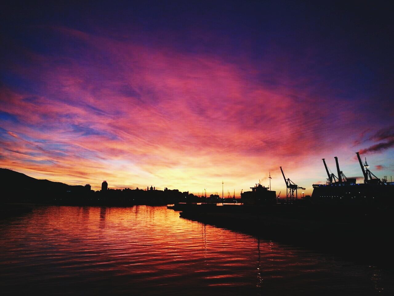 sunset, water, sky, silhouette, cloud - sky, waterfront, built structure, orange color, architecture, harbor, river, cloud, reflection, scenics, building exterior, cloudy, dusk, beauty in nature, tranquil scene, dramatic sky