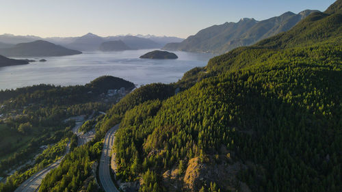 Scenic view of sea and mountains against sky