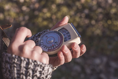 Cropped image of person holding antique navigational compass