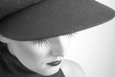 Close-up portrait of girl wearing hat