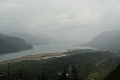 Scenic view of sea and mountains against sky