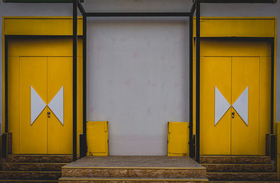 Close-up of yellow sign on wall