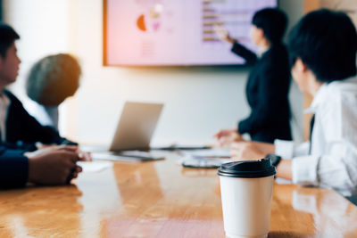 Businesswoman discussing graph with colleagues