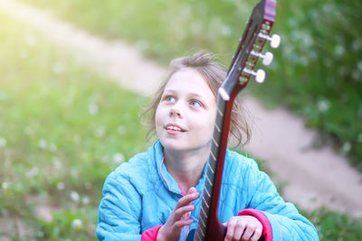 Portrait of a smiling girl holding outdoors