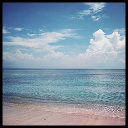 Scenic view of sea against cloudy sky