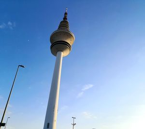 Low angle view of communications tower against sky