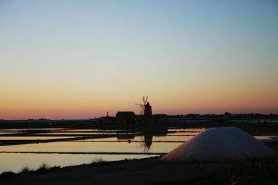 Silhouette built structure against clear sky during sunset
