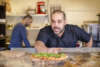 Young man preparing food in kitchen