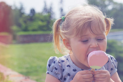 Close-up of cute girl eating ice cream