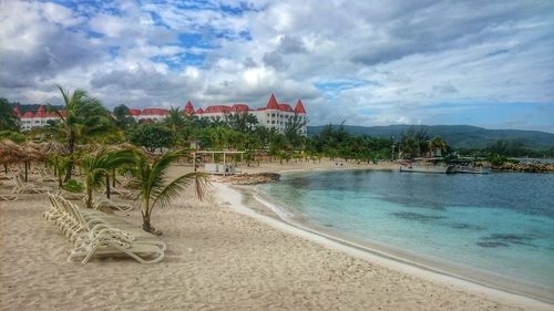 Scenic view of beach against cloudy sky