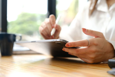 Midsection of woman using mobile phone