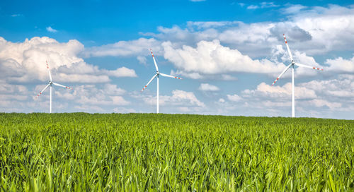 Windmill on field against sky