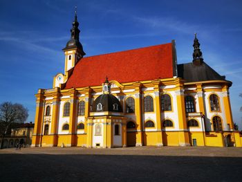 Low angle view of illuminated building against sky at dusk