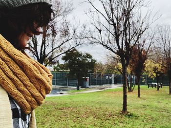 Side view of woman standing in park